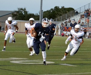 Junior Josh Adkins sprints towards the end zone evading the opposing team.