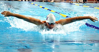 Junior Cole Mansker performs the 100 Butterfly, breaking the previous record on Feb. 5. 