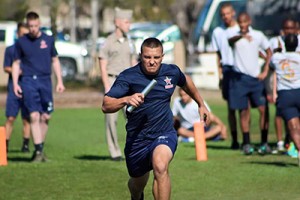 Senior Ben Alino races holding the baton this past weekend during the NJROTC meet. Photo by: Hanna Randle