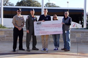 Senior Colt Hermesch holds his giant check for $180,000 NJROTC scholarship to MIT on Feb. 26 outside the school.