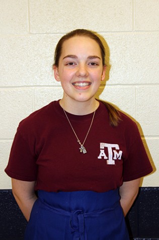 Junior Andie O'Brien smiles while wearing her apron on Feb. 4.