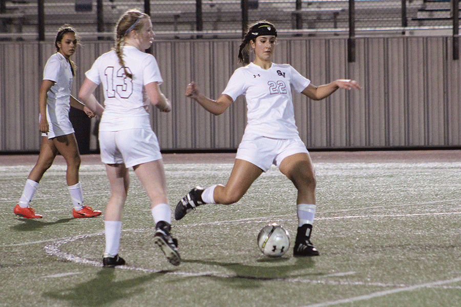 Senior Victoria Andrade starts to kick the ball on Feb. 4.