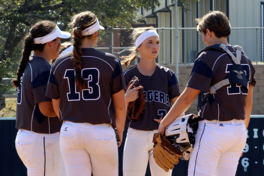 Kat Mattys, Abby Winkler, Natalia Reeves, Hailey Padilla have a conference on the mound.