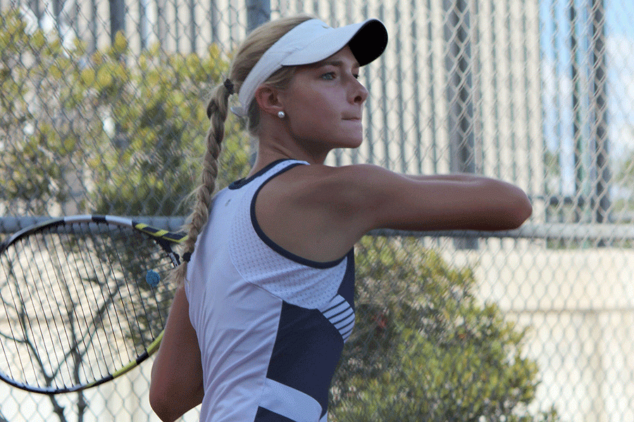 Senior Olivia Chuber swings the tennis racket on March 4 during practice. 