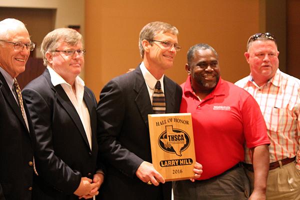 Hill shows off his Hall of Honor plaque at the Texas Ballroom in the Grand Hyatt hotel on July 20.