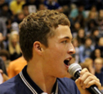 Junior cheer manager Jacob Riggs addresses the crowd.