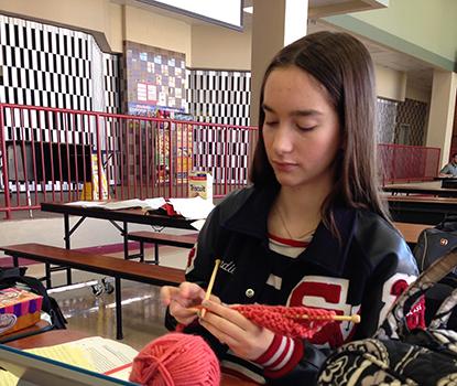 Senior Bradie Dean knits in her downtime at the UIL meet at Judson.