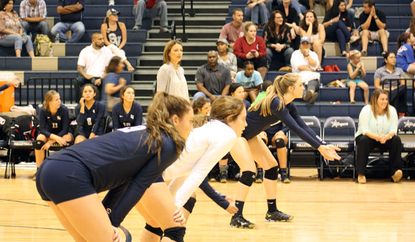 Varsity players wait for the Churchill serve Aug. 29th in the main gym at home.
