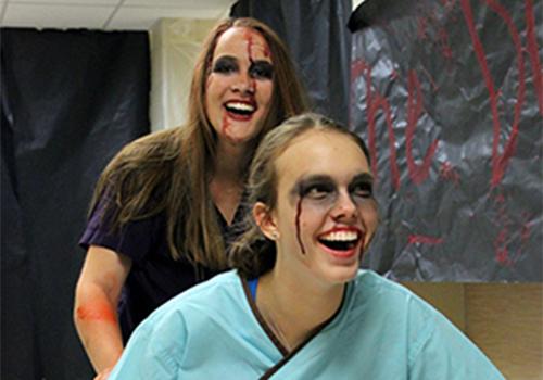 Seniors Morgan Clinton and Alexis Housson make their way down the hallway during Fall Fest. 
