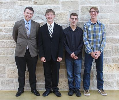 National Merit Semifinalists Jared Pauletti, Jacob Foster, Tony Perez and Donald Snodgrass smile in the main hallway. The four will have a chance to qualify for National Merit Finalists in February.