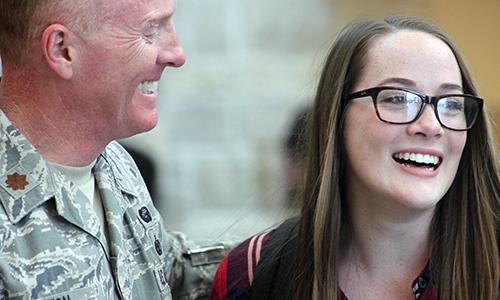 Army Major Kevin Clinton celebrates his homecoming with senior Morgan Clinton Friday morning in the D wing entrance.