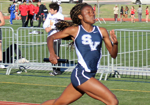 Senior Jianni McDole runs a leg in a relay event during the Feb. 25 Tiger Relays.