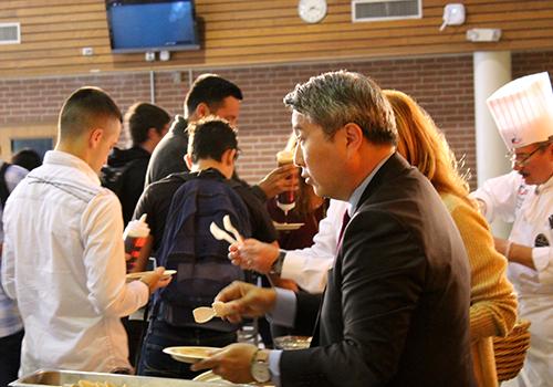 Superintendent Andrew Kim serves pancakes to the student body before school.