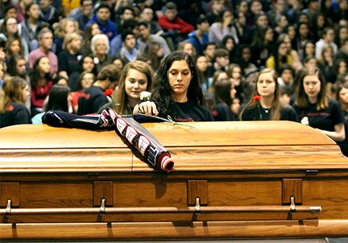 Giselle Kowalski and other FACS students pay respects at mock memorial.