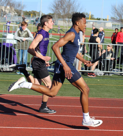 Freshman Greg Eggleston carries baton for team during Tiger Relays at Dripping Springs on Feb 25.