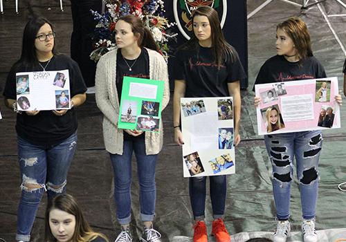 Students present obituaries of the living dead.