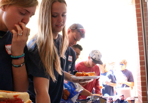 After volunteering all morning at the STAR track meet, FACS members chow down on hot dogs and all the fixings,=,