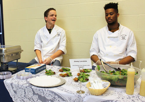Connor Rush shares a laugh with Jimmy Lavalais. "I made jerk chicken, and I made this because because I wanted to make something different that was culturally unique," Lavalais said.