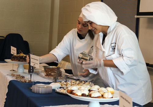 Andie O'Brien and Briana Esperiqueta put the finishing touches on the dessert table. “I made a chocolate hazelnut crepe cake," O'Brien said. " I saw it on Pintrest, so that’s why i made it." Esperiqueta made mini cannolis with chocolate chips. "I made it because I love cannolis," she said.
