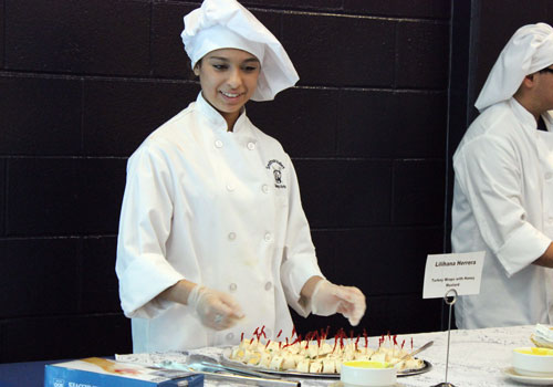 Lilihana Herrera serves turkey and cheese wraps with a honey mustard sauce. "I made it because I love eating healthy," she said, "and I want people to try my entree."