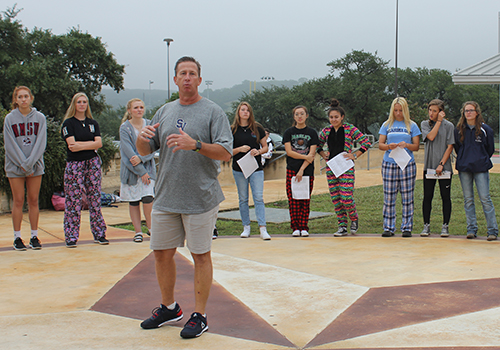 Students listen to Pastor Denis Rohlmeier speak about the importance of christianity.
