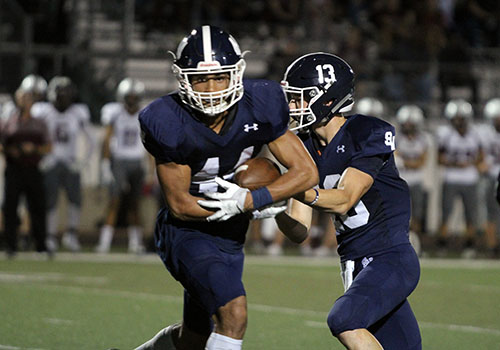 Senior Trevon Moehrig-Woodard receives the handoff from junior quarterback Levi Williams during the 50-10 win vs Round Rock.