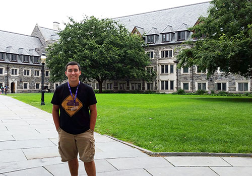 Brandon Warren stands in front of Princeton University where he attended a summer workshop on global politics. 