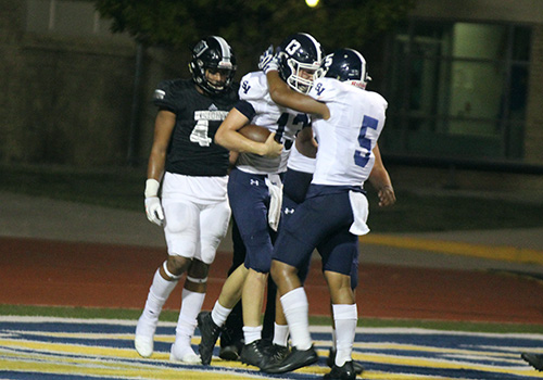 Junior QB Levi Williams celebrates one of his two rushing touchdowns with senior tight end Adoryzel Hunter during the 43-20 win over Steele.
