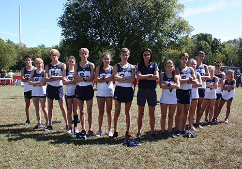 Varsity cross country boys and girls celebrate their formidable showing with Coach Brittney Lanehart at the Chili Pepper festival in Arkansas on Sept. 30.