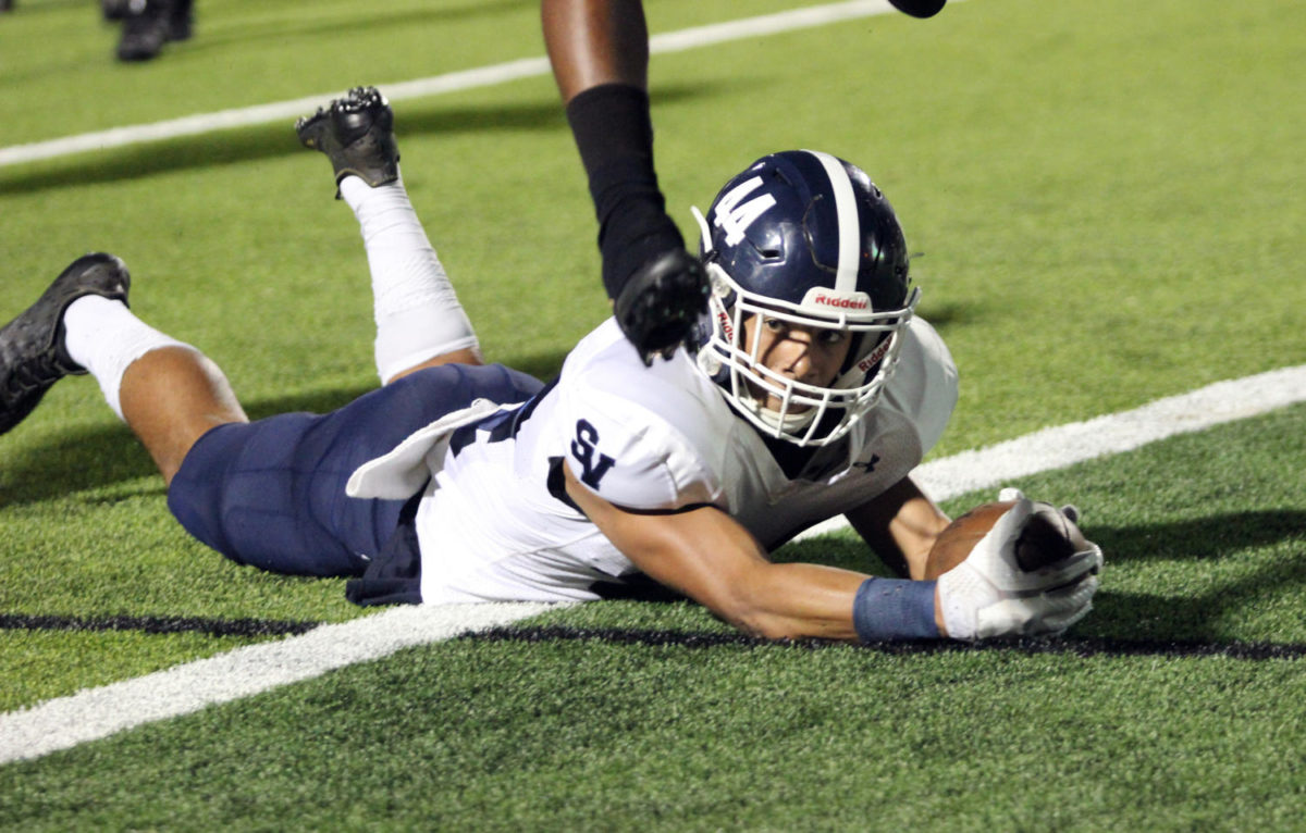 Senior standout Trevon Moehrig-Woodard stretches ball out to score. 
