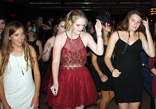 Seniors Olivia Kershner, Nicole Langley and Emma Sipple dance to the "Cupid Shuffle" at the Homecoming dance Saturday.