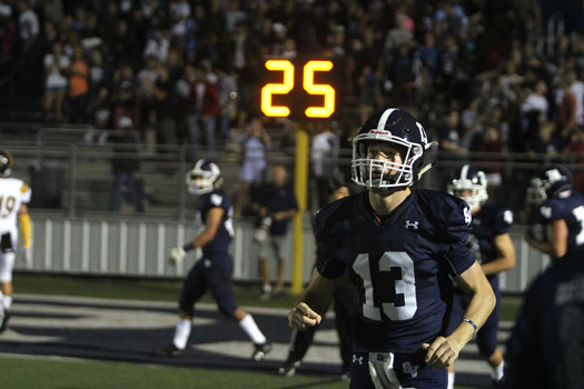 Junior quarterback Levi Williams jogs off the field after a touchdown during the teams game against East Central. The team defeated the Hornets 54-0 on homecoming on Sept. 29. 