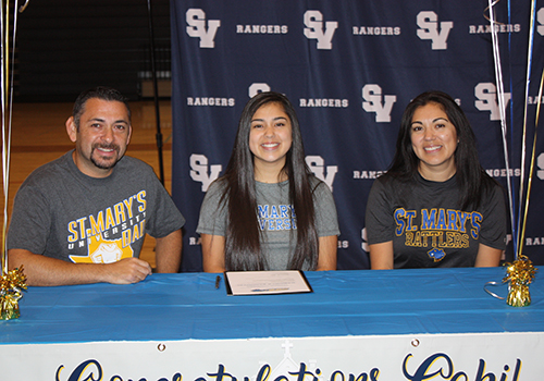 Senior libero Gabi Sandoval signs her commitment to play for
St. Mary's University on Nov. 8.