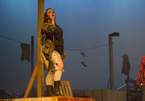 Katy Mitchell as Mercutio makes fun of Romeo in hopes to stop him from hiding.