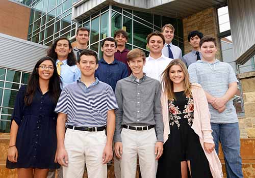 National Merit Commended Scholars and National Hispanic Recognized students stand in front of the main entrance of SV. Before the football game on Oct. 20, the students had a dinner where they were recognized.