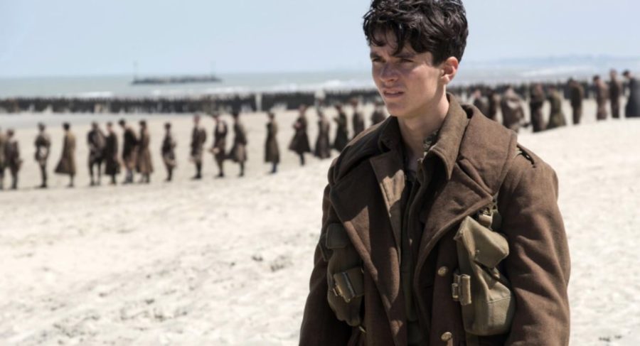 An image from Christopher Nolan's Dunkirk. A soldier stands on the beach of Dunkirk, awaiting the arrival of help.