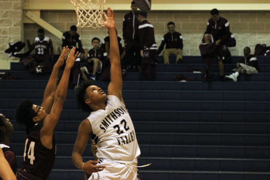 Junior Dylan Sinegal drives through for a layup against Highlands on Nov. 14.