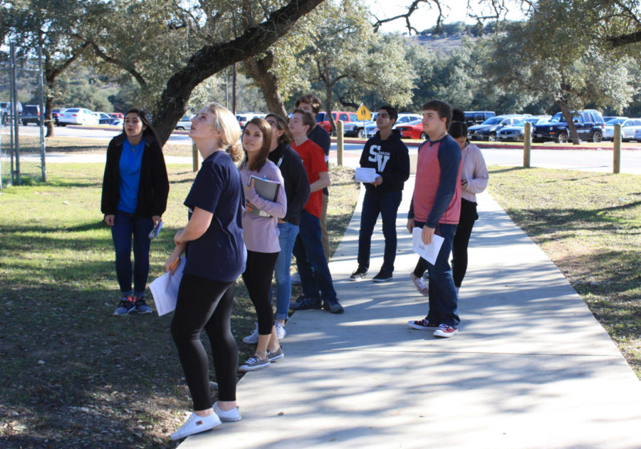 Keven Harshbarger's AP physics class watches as the other students prepare to drop their eggs from the football stadium during seventh period.