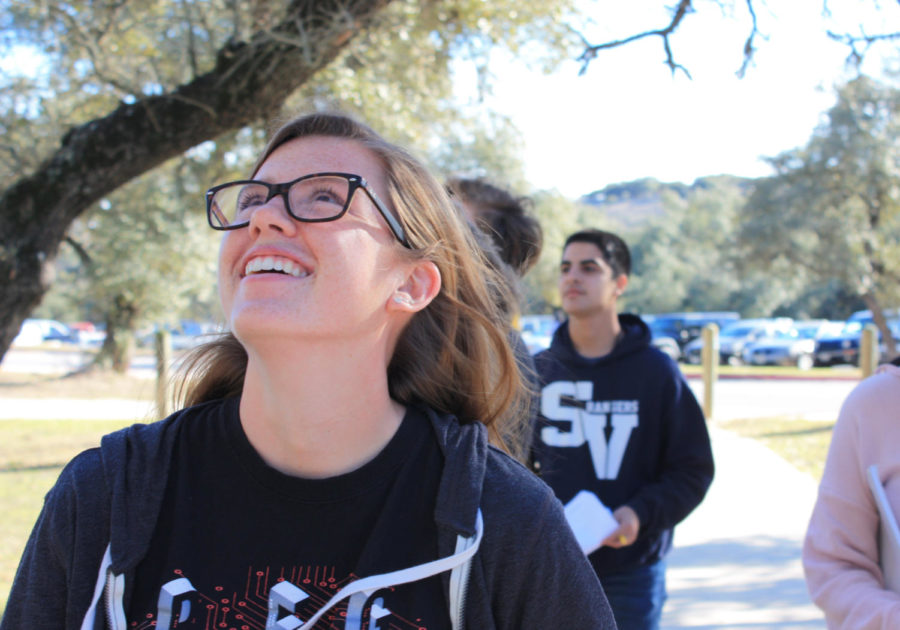 Makenzie Thornley watches the other groups test their eggs; excited to see how the eggs fare during seventh period's experiment, she smiles on. 