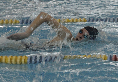 Senior Emily competes in the women's 100 freestyle at the Reagan meet. 