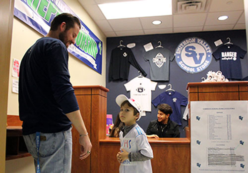 Theatre teacher Casey O'Bryant buys a new hat for his son.