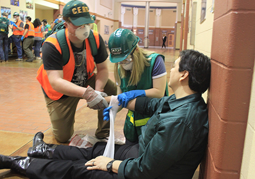 Senior Luke Snell and sophomore Ally Cravens help Jason Gonzalez recover form a "dangerous injury" during their Community Emergency Response Team training on Feb. 27.