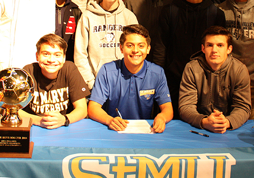 Johnathan Diaz, Nathaniel Diaz and Luis Green pose as Nathaniel Diaz signs his letter of intent. He will play soccer at Saint Mary's University. "It's close to home," he said.   