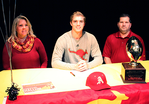 Christian Hallum sits in between his parents at his signing to Austin College. He will play football there. "It felt like it fit," he said. "I liked what the program and coaches stood for. I can see myself there."