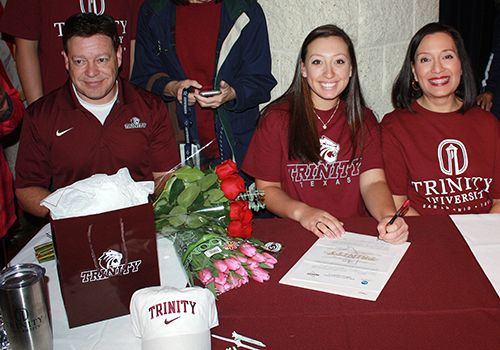 Raquel Hill sit in between her parents, signing her letter of intent. She will golf at Trinity University. "It's a really small school," Hill said. "I really liked the coach and atmosphere." 
