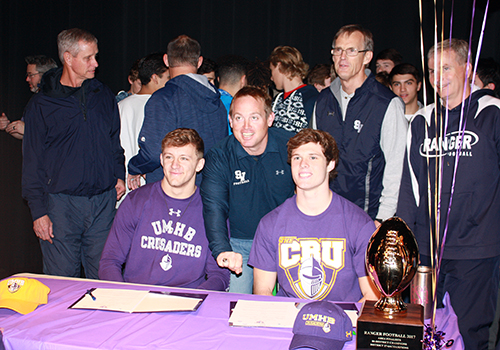 CJ Kuehler, coach Jeff Shinn and Jacob Zuber pose at the signing table. Kuehler and Zuber signed to play football at the University of Mary Harding Baylor. "The school had a winning tradition, good coaching and a beautiful environment," Kuehler said.
