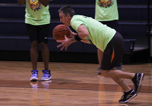 After stealing back the ball, principal Michael Wahl  heads to the basket during the faculty-student basketball game for SPUD week Wednesday.