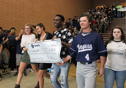 Smithson Valley Athletics representatives present a check for the $225 raised during the Specht's General Store Spirit on March 4.
