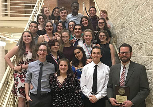 The cast and crew of "Man From Nebraska" stands on the staircase by the auditorium last Friday. The show will have a public performance Wednesday for free at 6:30 p.m.
