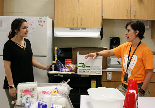 Senior Maddy Horberg and Tina Olcott plan how to take the rest of the food from the 30 hour famine breakfast back to Olcott's room last year, on April 18.